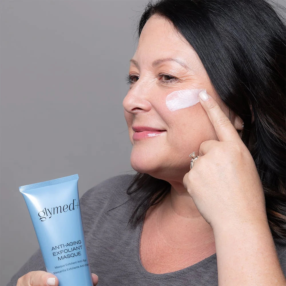 Woman using Glymed+ Anti-Aging Exfoliant Masque on face