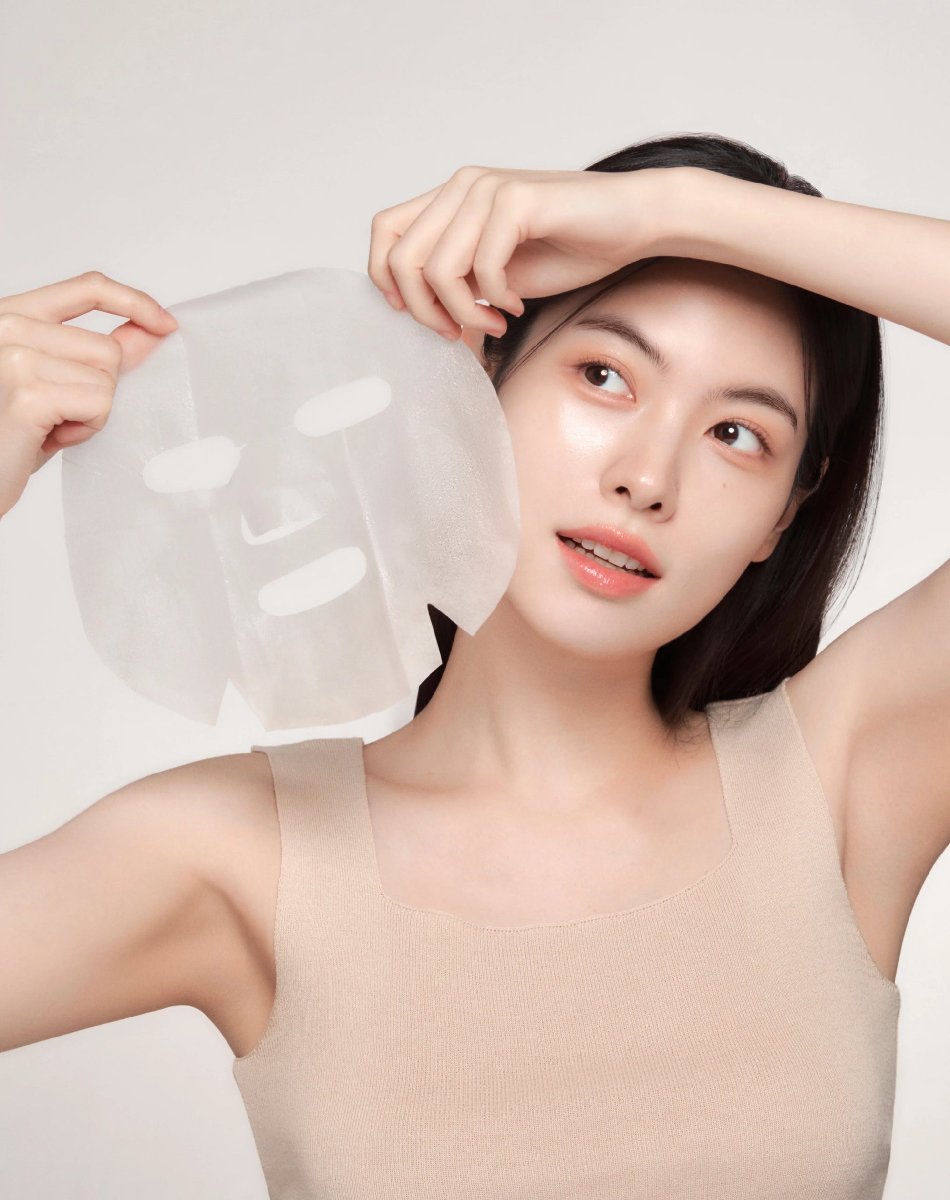 Woman holding IDENEL Sheet Mask